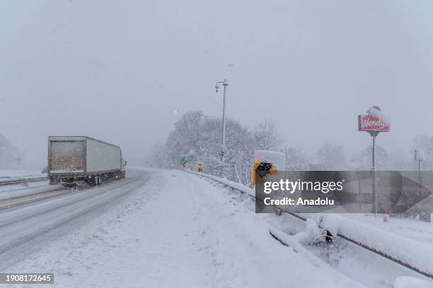 Truck is passing through on the road during snowstorm in Cambridge, Massachusetts, United States on January 7, 2024.