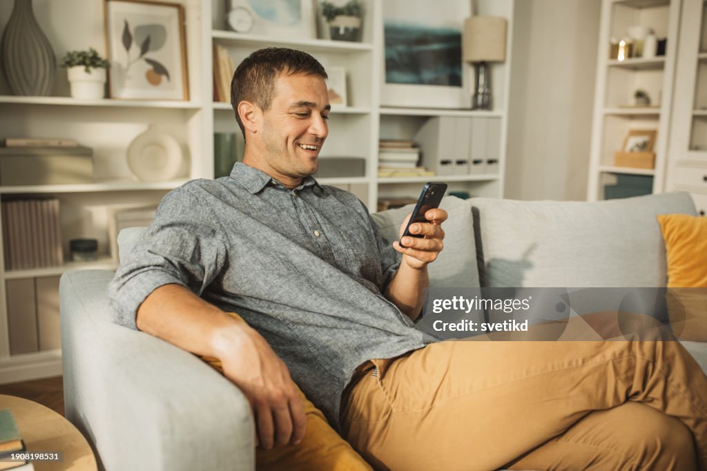 Young man using smart phone at home