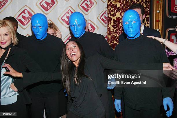 Guide Channel host Cynthia Garrett poses with the "Blue Man Group" at the TV Guide Channel Upfront celebration at SHOW April 9, 2003 in New York City.