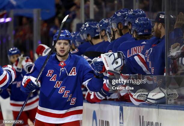 Artemi Panarin of the New York Rangers celebrates his goal with teammates on the bench during the first period against the Chicago Blackhawks at...