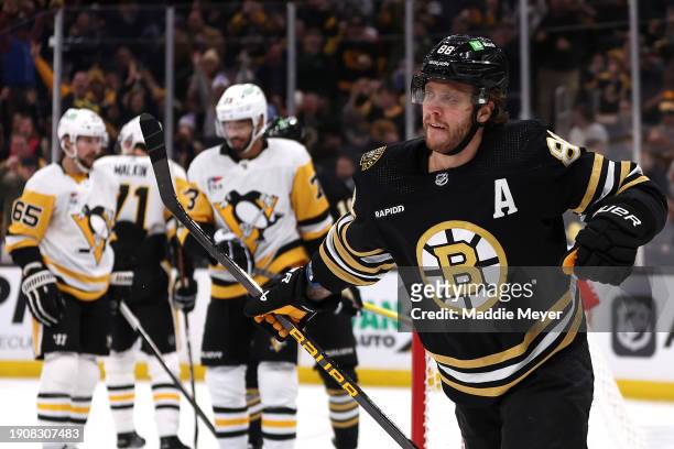 David Pastrnak of the Boston Bruins celebrates after scoring against the Pittsburgh Penguins during the first period at TD Garden on January 04, 2024...