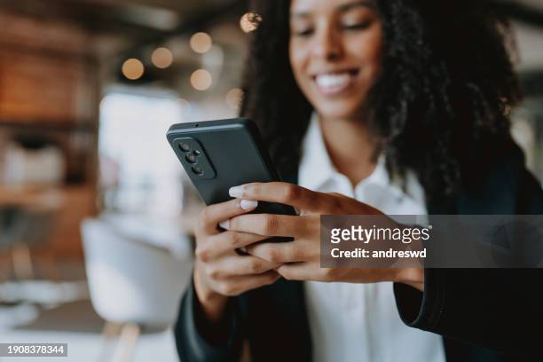 young businesswoman using smartphone - creative agency stock pictures, royalty-free photos & images