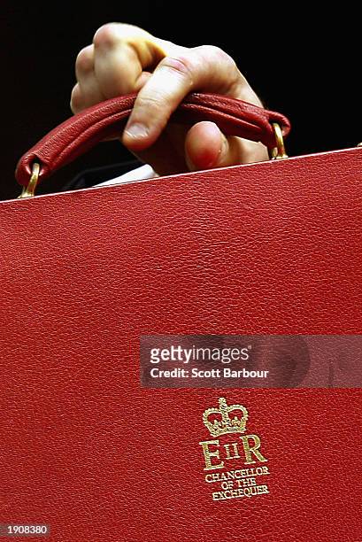 Britain's Chancellor of the Exchequer, Gordon Brown holds his briefcase aloft which contains the budget April 9, 2003 in London, England.