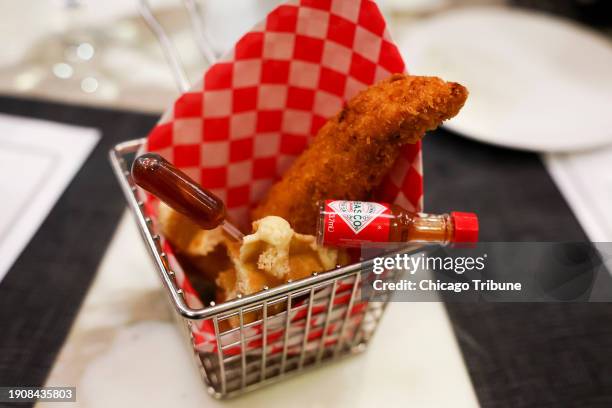 Chicken and waffles served with maple syrup in a pipette, shown at Levy's test kitchen in Streeterville, were a unanimous hit and will be on the 2024...