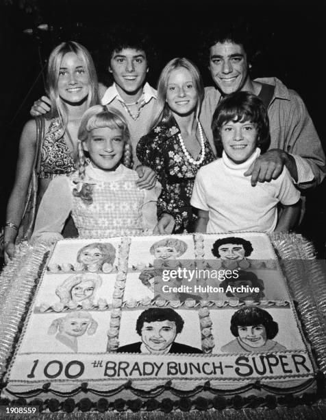 Young cast members of the television series, 'The Brady Bunch' pose with a cake celebrating the show's 100th episode, circa 1973. : Maureen...