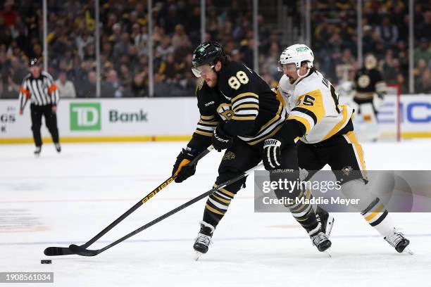 Erik Karlsson of the Pittsburgh Penguins defends David Pastrnak of the Boston Bruins during the third period at TD Garden on January 04, 2024 in...