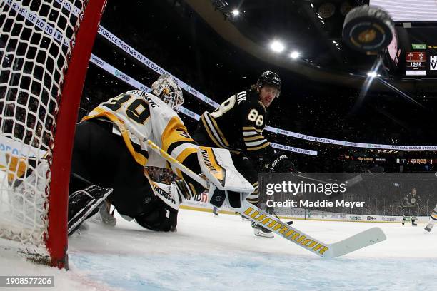 David Pastrnak of the Boston Bruins scores a goal against Alex Nedeljkovic of the Pittsburgh Penguins during the first period at TD Garden on January...