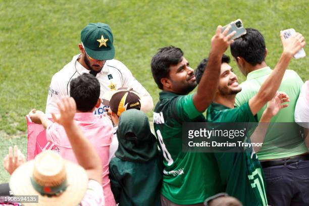 Hasan Ali of Pakistan signs autographs during day three of the Men's Third Test Match in the series between Australia and Pakistan at Sydney Cricket...