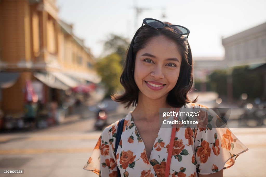 Portrait of a smiling woman in the city
