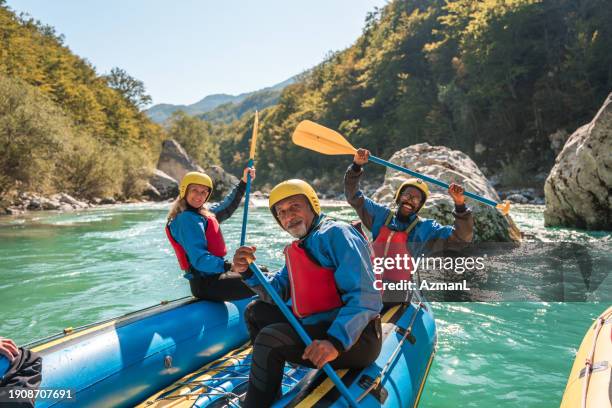 diverse mature group river rafting in natural setting - northern california vacation stock pictures, royalty-free photos & images