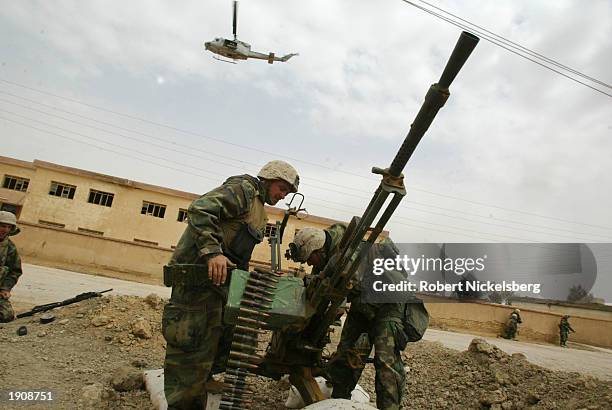 Marines of the 1st Marine Division outside the city of Tahrir prepare March 30, 2003 to destroy a 14.5 caliber Iraqi anti-aircraft gun in Tahrir,...