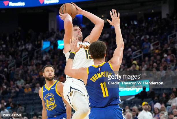 Nikola Jokic of the Denver Nuggets shoots the ball against Klay Thompson of the Golden State Warriors during the third quarter at Chase Center on...