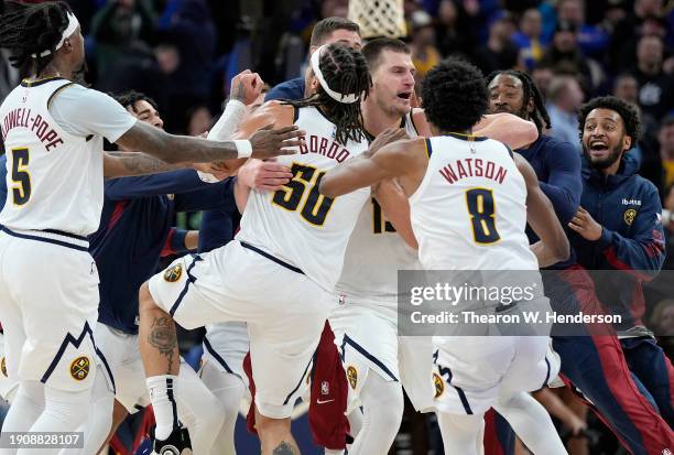 Nikola Jokic of the Denver Nuggets celebrates with teammates after scoring a game winning three-point shot at the end of the fourth quarter to defeat...