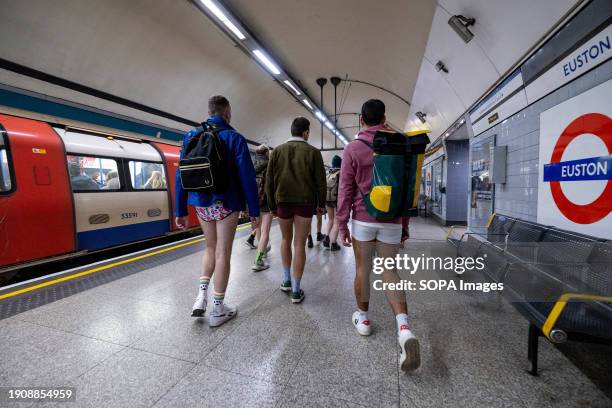 No Trousers Tube Ride" participants without pants on their way to ride a train on the London Underground. Participants in the "No Trousers Tube Ride"...