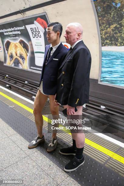 Participants wait at Euston station during the annual "No Trousers Tube Ride" event on the London Underground. During the annual event, "No Trousers...