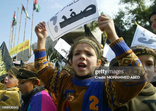 Palestinian girl holds up a placard reading in Arabic: " I will be back to Safad" during a demonstration against the so-called Geneva Initiative held...