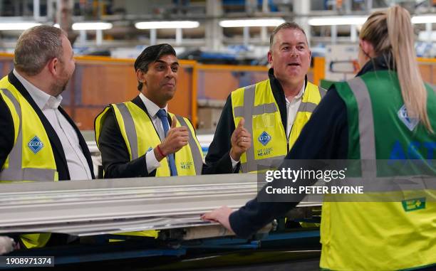 Britain's Prime Minister Rishi Sunak makes a thumbs-up sign, standing alongside VEKA Managing Director Neil Evans and Conservative MP for Burnley,...