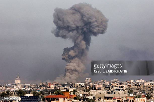 Smoke plume erupts over Khan Yunis from Rafah in the southern Gaza strip during Israeli bombardment on January 8, 2024 amid the ongoing conflict...