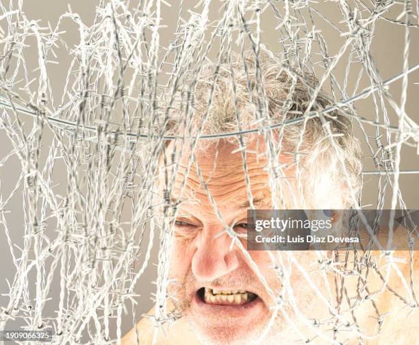 man behind a barbed wire - under arrest stock pictures, royalty-free photos & images