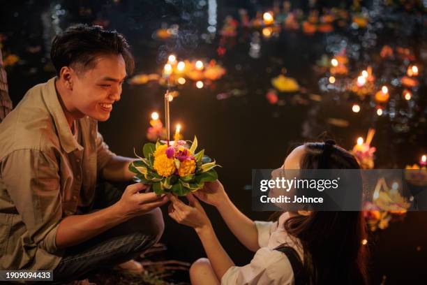 couple at the loy krathong festival - loi krathong festival stock pictures, royalty-free photos & images