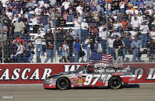 Kurt Busch,driver of the Roush Racing Rubbermaid Ford takes a victory lap after winning the NASCAR Winston Cup Food City 500 at Bristol Motor...