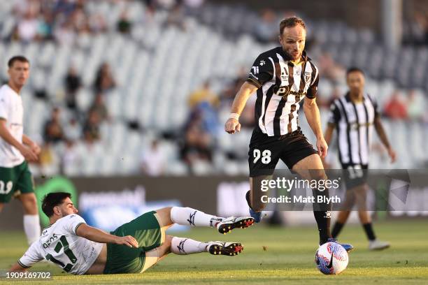 Valere Germain of Macarthur FC is tackled by Kostandinos Grozos of the Jets during the A-League Men round 11 match between Macarthur FC and Newcastle...