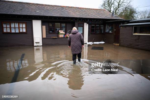 Doreen Cole surveys the damage to her property after heavy rains and sewer system overflows caused the River Cherwell to break its banks on January...