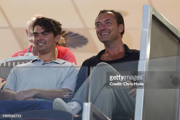 Actor Jude Law and son Rudy watch Aryna Sabalenka of Belarus against Daria Kasatkina during day six of the 2024 Brisbane International at Queensland...