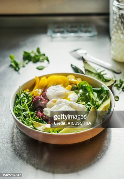 healthy breakfast bowl with avocado,poached eggs, green salad, yellow and red vegetables - paleo diet stock pictures, royalty-free photos & images