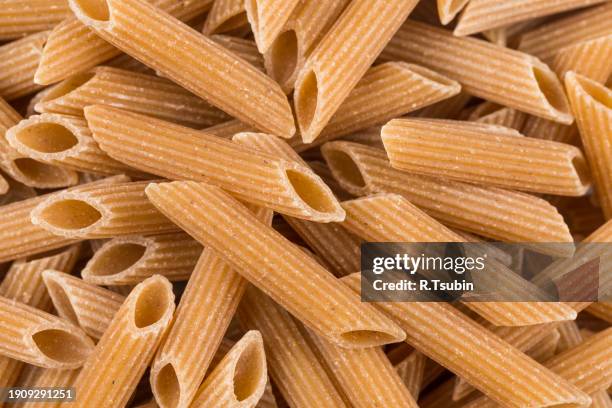 wholegrain penne pasta - vollkorn stock pictures, royalty-free photos & images