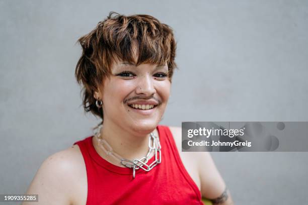 relaxed and cheerful transgender man in early 20s - chain link tattoo stock pictures, royalty-free photos & images