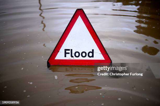 Flood warning sign stands in the flooded Radcliffe Residential Park where residents were evacuated due to flooding in the aftermath of Storm Henk and...