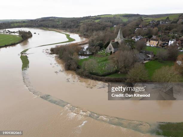 In this aerial view, the village of Alfriston is surrounded by flood water after the River Cuckmere burst its banks on January 05, 2024 in Alfriston,...