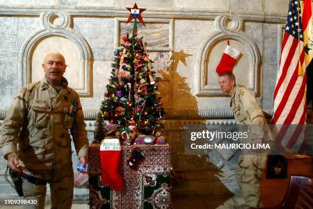 Lt Colonel Steven Russell commander of the US 1-22 Battalion of the 4th Infantry Division , turns on the lights of a Christmas tree beside Sargent...