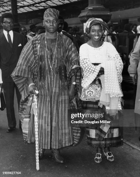 Nigerian Royal Oba Ademuwagun Adesida II, of the House of Adesida, wearing an agbada, and his wife, Olori Adebola Asake Adesida, who wears...