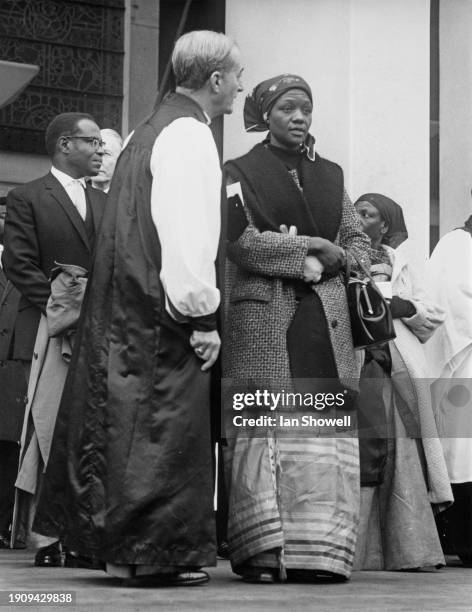 Clergyman in conversation with the widow of 'King Freddie' , Bugandan Royal Lady Damali , the Nnabagereka, at the King's funeral service, held at the...