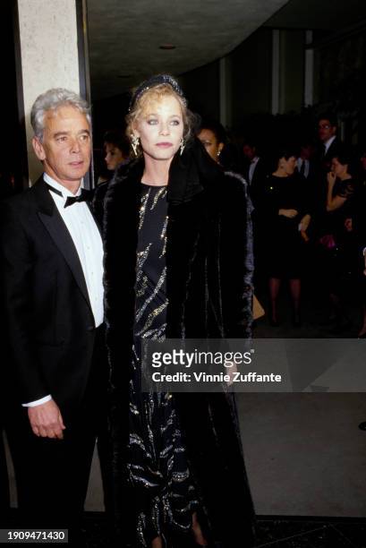 American television producer Bernard Sofronski, wearing a tuxedo and bow tie, and American actress Susan Dey, who wears a black coat over a black...