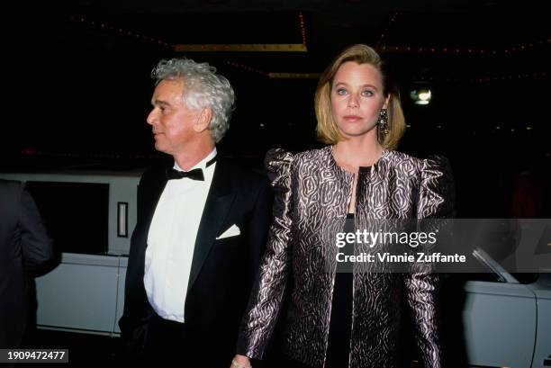 American television producer Bernard Sofronski, wearing a tuxedo and bow tie, with is wife, American actress Susan Dey, who wears a black-and-silver...