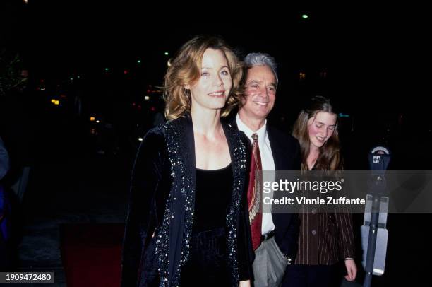 American actress Susan Dey, wearing a black outfit with a black jacket featuring gold detail on the chest, and her husband, American television...