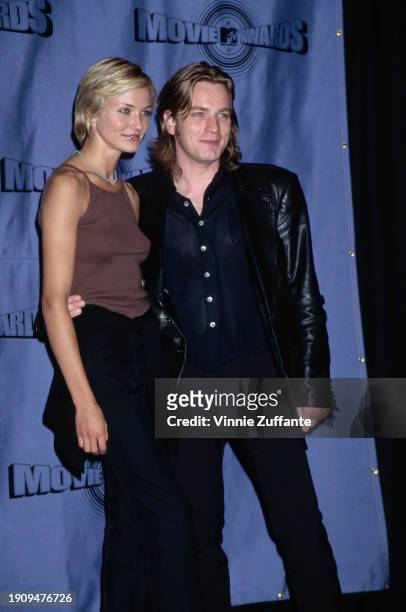 American actress Cameron Diaz, wearing a brown vest with black trousers and a turquoise necklace, and British actor Ewan McGregor, who wears a black...