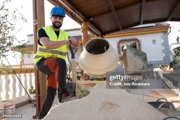 40-year-old construction worker renovating a house in outdoors patio - masonry tools stock pictures, royalty-free photos & images