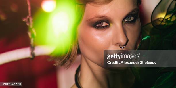 circus and cabaret photography, vintage burlesque photo. female portrait of a beautiful woman at the performance show indoors, fashion style with neon light effects. - circus artist stock pictures, royalty-free photos & images