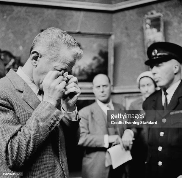 Dealer examines a diamond valued at £27,000 at Christie's auction house, London, June 18th 1958.