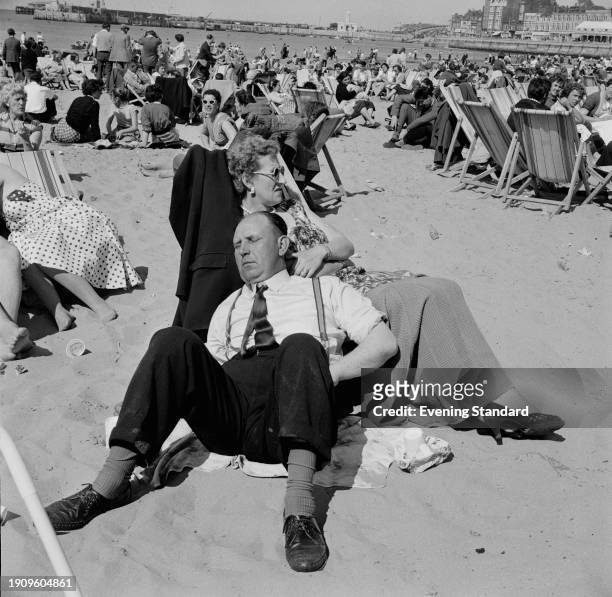 Man napping on a crowded beach in Margate, Kent, June 16th 1958.