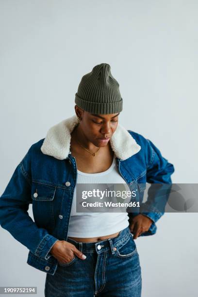 woman wearing denim jacket against white background - completamente desabrochado fotografías e imágenes de stock