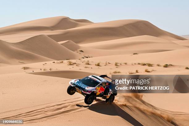 Nasser Racing's Qatari driver Nasser Al-Attiyah and his French co-driver Matthieu Baumel compete during Stage 3 of the Dakar Rally 2024, between Al...