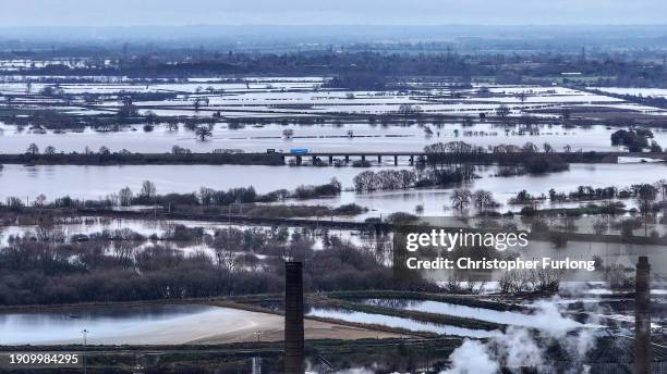 In this aerial view in the aftermath of Storm Henk, fields and roads are flooded after the River Trent burst its banks with a major incident declared...