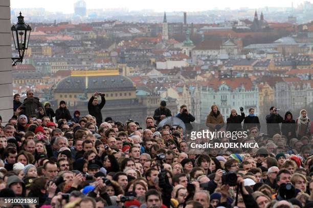 Thousands of people watch at the horse drawn hearse carrying the flag draped coffin of former Czech president Vaclav Havel arrives at the Castle in...