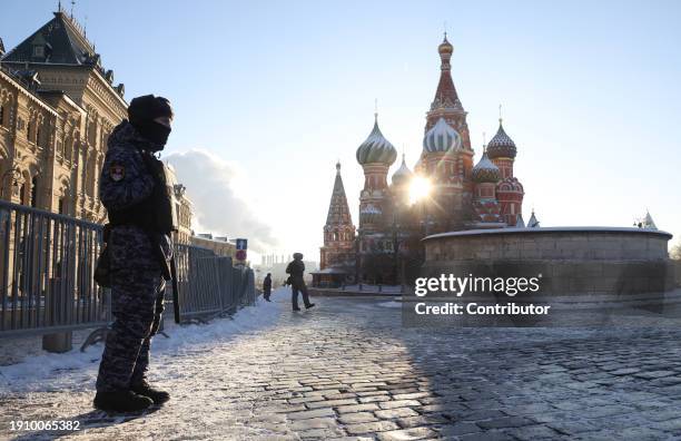 Russian National Guard Service offcers guard the Red Square near the Saint Basile's Cathedral, as air temperatures dropped to -18 degrees Celcius,...