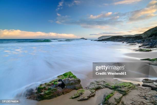 france, brittany, long exposure of cap frehel beach at dusk - cap fréhel stock pictures, royalty-free photos & images